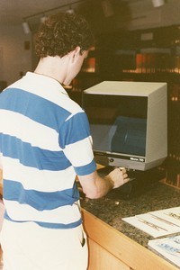 O'Neill Library interior: student standing at microfilm machine