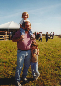 My husband with our girls at Farm Day