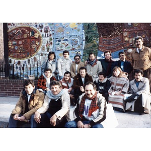 Group portrait in front of the ceramic tile mural.