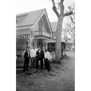 Alex Alvear and Claudio Ragazzi with two unidentified men pose in front of a house.