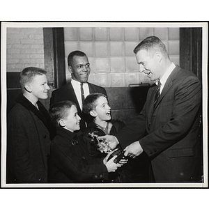 Two boys receive a trophy in the 40th Boys' Clubs of Boston Basketball Tournament