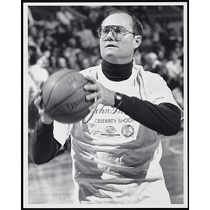 Former Boston Celtics player Steve Kuberski holding a basketball ready to shoot at a fund-raising event held by the Boys and Girls Clubs of Boston and Boston Celtics