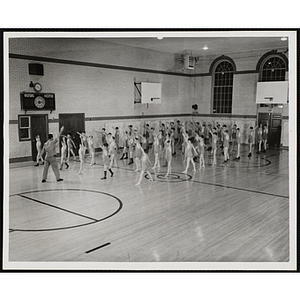 About fifty boys doing warm-up exercises in the South Boston Boys' Club gymnasium