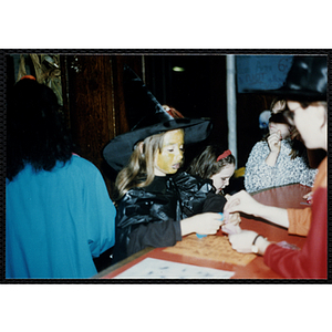 A girl in a costume attends a Halloween event