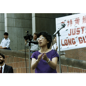Chinese Progressive Association director Suzanne Lee claps as she speaks at a rally for Long Guang Huang at City Hall Plaza in Boston