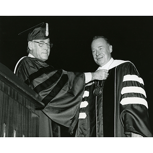 Chairman Willis bestows the University's presidential laveliere on Kenneth g. Ryder