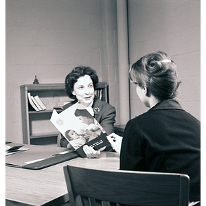 Charlotte Voss, Dean of Nursing, showing a brochure