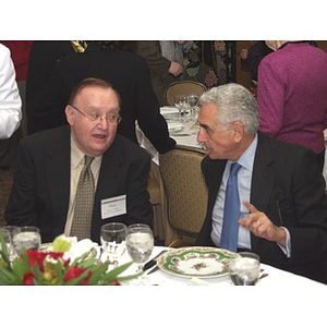 Barry Karger, left, talks with John Hatsopoulos at a table at gala dinner