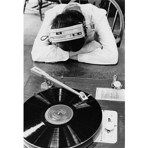 Student listening to a record in Snell Library