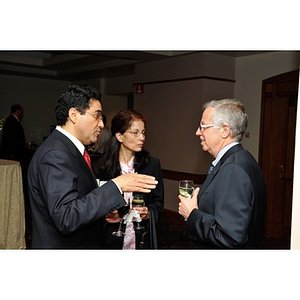 Ahmed and Zena Busnaina speaking with another guest at NU Night at the Pops