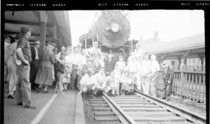 Group of people posing in front of the train at Haverhill Station, Haverhill, Mass.