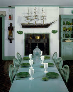 Interior view of Golden Step Room dining table with model ship over fireplace, Beauport, Sleeper-McCann House, Gloucester, Mass.