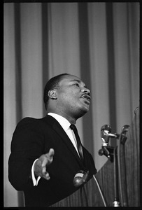 Martin Luther King, Jr., speaking from a podium