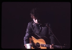 Bob Dylan performing on stage: grabbing a cup of water