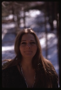 Judy Collins: half-length portrait in a green sweater, laughing