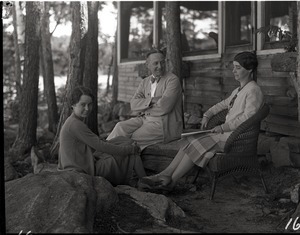 Dorothy and L.D. Roys seated on the porch at Camp Idlewild with unidentified woman
