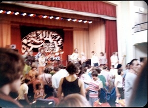 Rapunzel concert, on stage at local school(?): band and audience