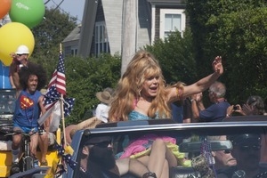 Grand Marshall Charo riding in the parade, waving to the crowd : Provincetown Carnival parade