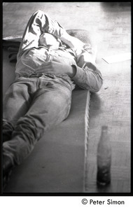Student sleeping on a mat on the floor : Vietnam War sanctuary at MIT
