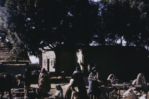 Women and children gather near the village well