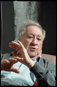 Fine art photographer Aaron Siskind: close-up portrait, seated in a armchair in his living room