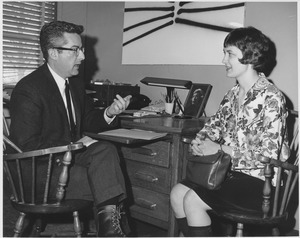Bernard G. Berenson sitting in office with student