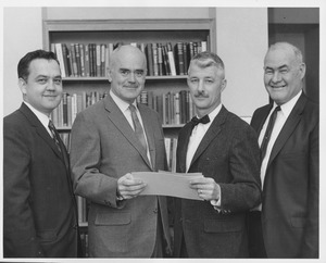 Carl A. Keyser receiving award from three men