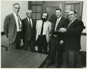 Dean John Denison standing indoors with Herbert Spindler, Russell Smith, Robert [Coler] and William Rice