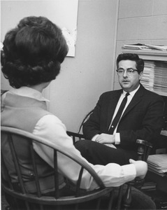 Bernard G. Berenson sitting in office with student