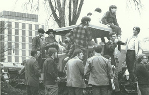 Students gather ontop of construction equipment