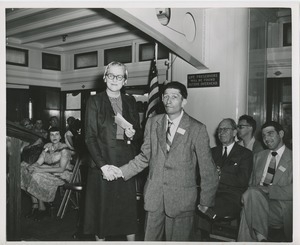 Woman and man shake hands on boat