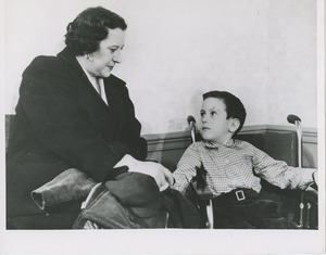 Young boy in wheelchair with mother or attendant