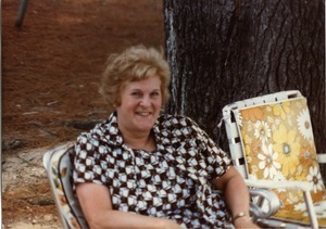 Woman seated in a folding chair at the picnic, Pine Beach