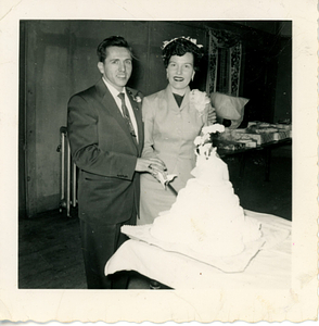 Richie Ares cutting cake with his wife