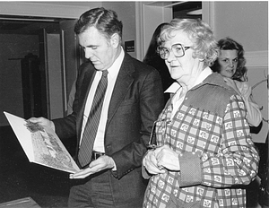 Mayor Raymond L. Flynn admiring a painting while standing with an unidentified woman