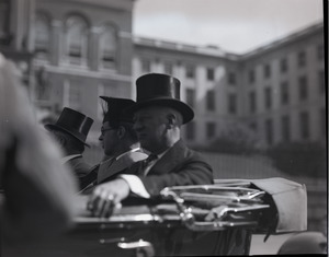 Gov. Alfred E. Smith riding in a motorcade past the State House