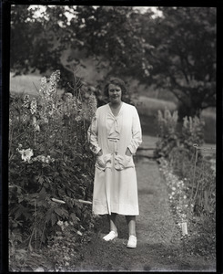 Dorothy Thompson, standing in her garden