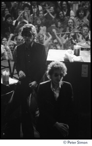 Bob Dylan walking on stage at the Boston Garden, followed by Robbie Robertson