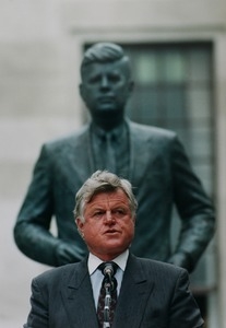 Edward M. Kennedy in front of statue to John F. Kennedy