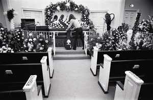 Duane Allman's funeral: musicians setting up with Duane Allman's casket in foreground, from left: Delaney Bramlett, Barry Oakley, Butch Trucks, and Thom Doucette