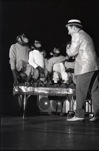 Chimpanzee vaudeville act opening for the Grateful Dead at Sargent Gym, Boston University: performer with pork-pie hat and chimpanzees balancing objects on their heads