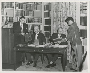 Presidents Bruce Barton of ICD and Carroll V. Newsom of NYU being presented with pens with which to sign an affiliation agreement