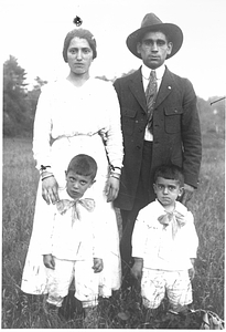 Family standing in field.