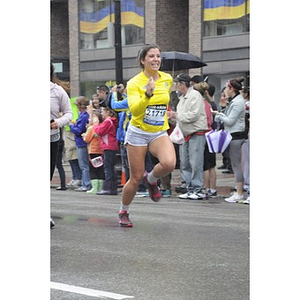 Woman runner smiles as she nears Copley Square finish line