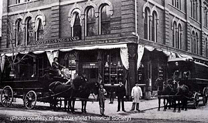 Open and covered delivery wagons, Cutler Brothers, Main and Lincoln Streets, 1885