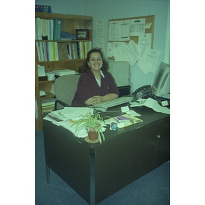 Woman at her desk in her office.