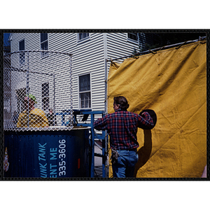 A man sets up a dunk tank at the Boys and Girls Clubs of Boston 100th Anniversary Celebration Street Fair