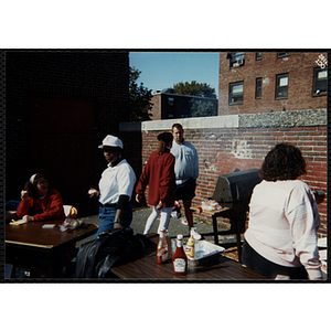 A girl and a man attend to a grill at a carnival