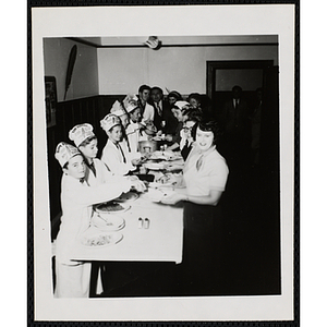 Members of the Tom Pappas Chefs' Club serve diners at a banquet table