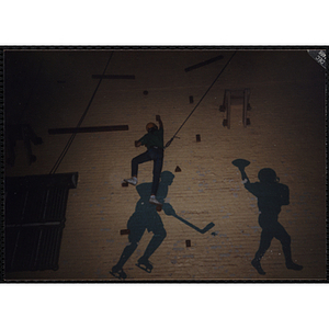 A child climbs up a wall in a gymnasium